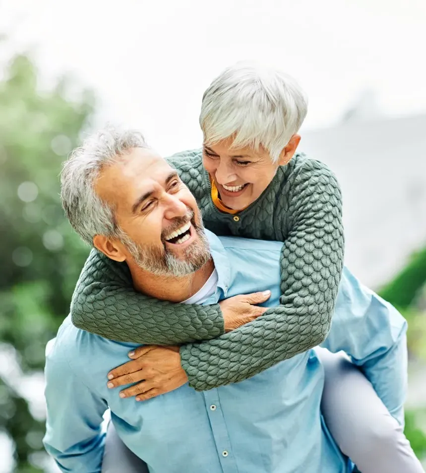 Senior couple walking hand in hand on a gravel path